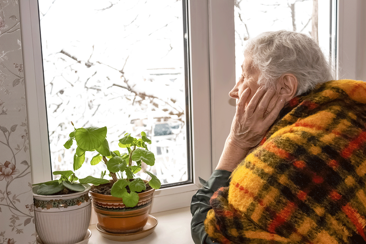 man looks out of the window and wonders about how to beat the winter blues