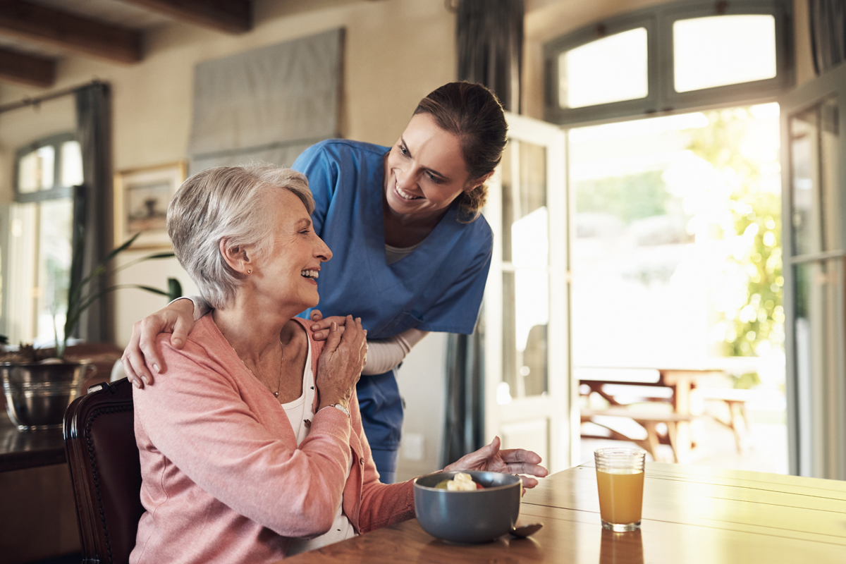 Worker touching senior's shoulder