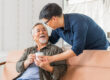 Son caretaker giving elderly father coffee